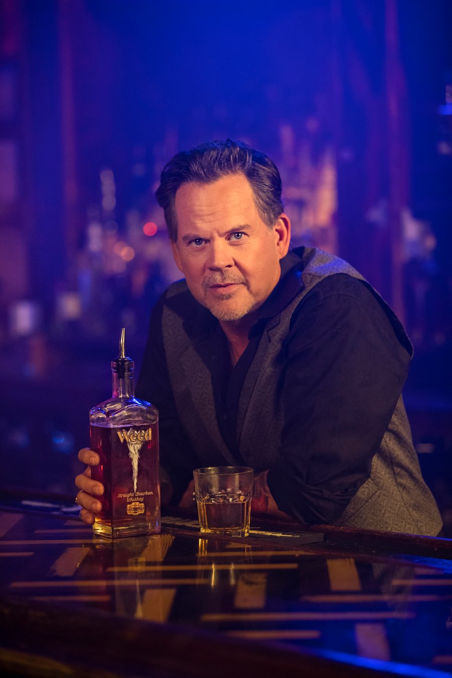 Gary Allan sitting at a bar with Weed Straight Burboun Whiskey!