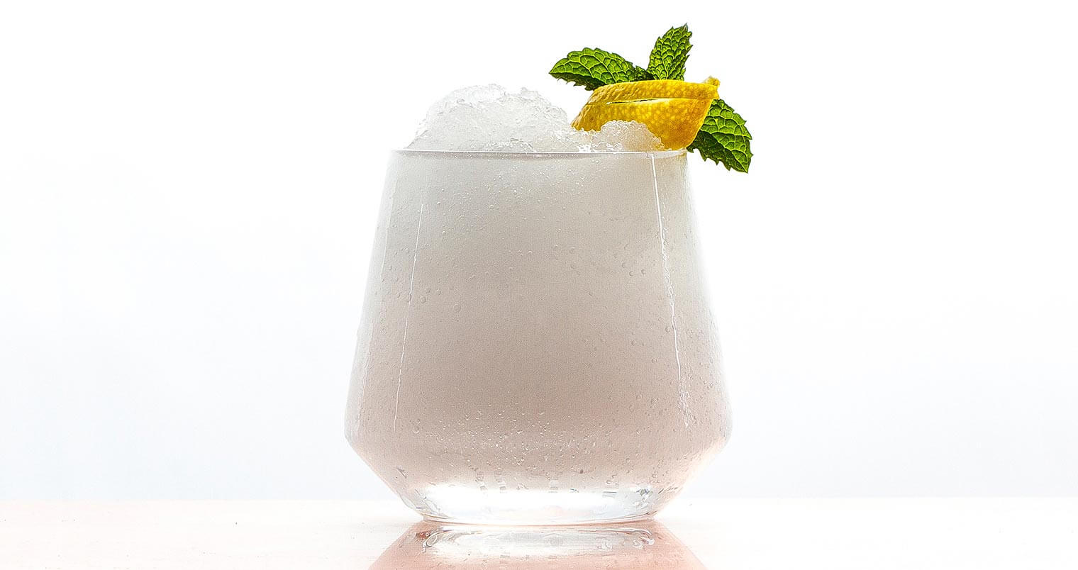 Absinthe Frappe, cocktail with garnish on white, featured image