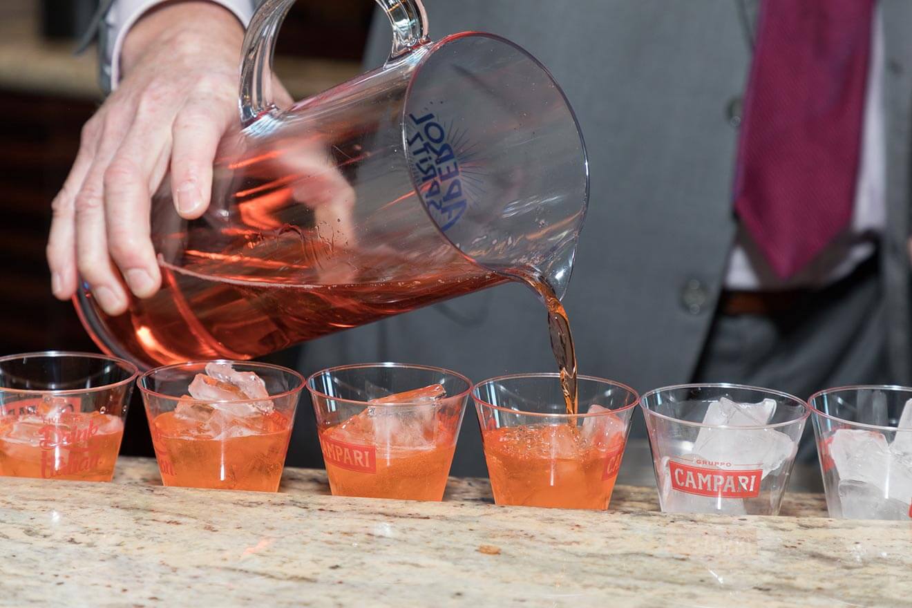 Aperol Spritz, cocktails in a row being mixed