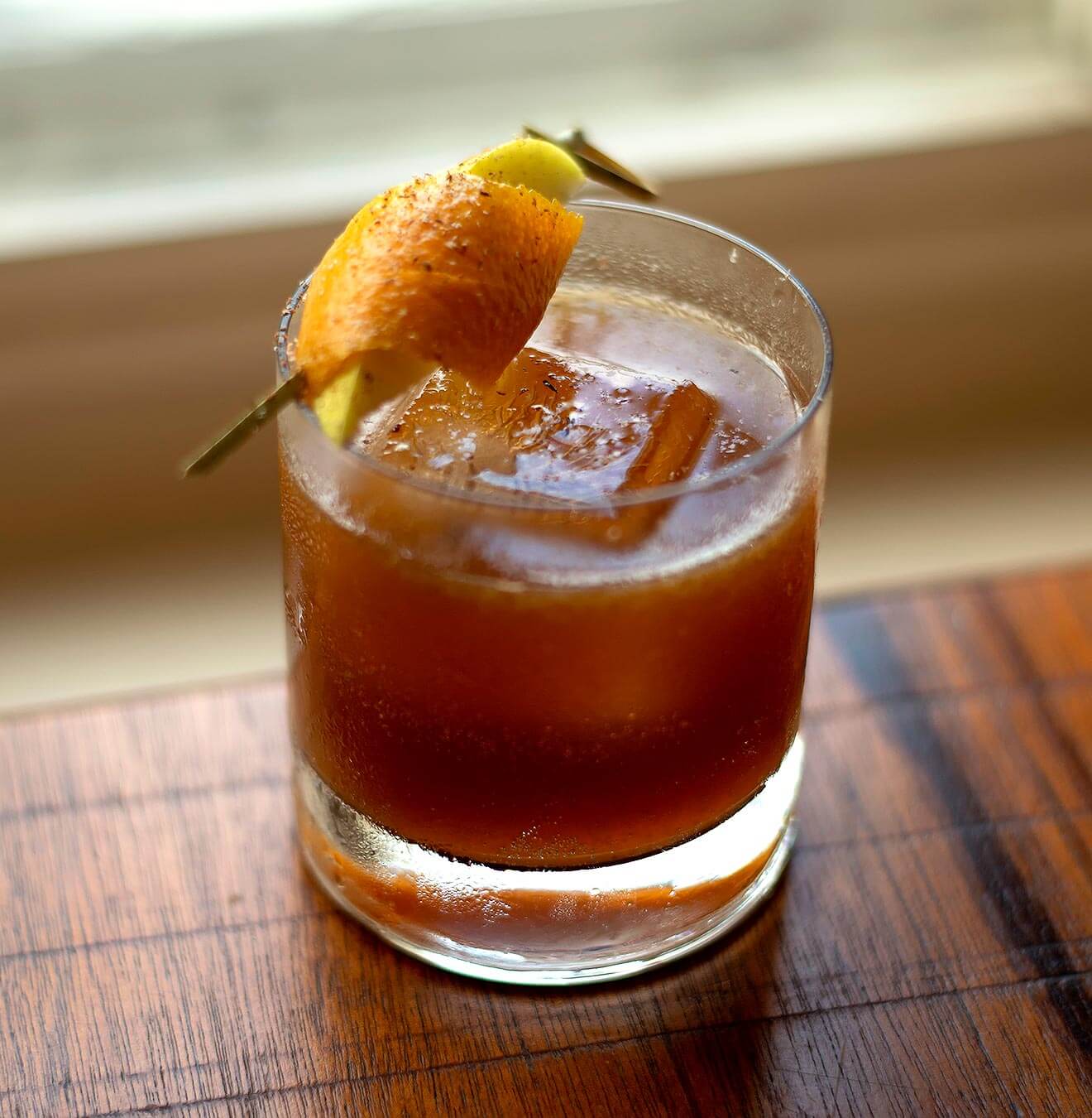 Apples to Apples, cocktail in windowsil, wood table