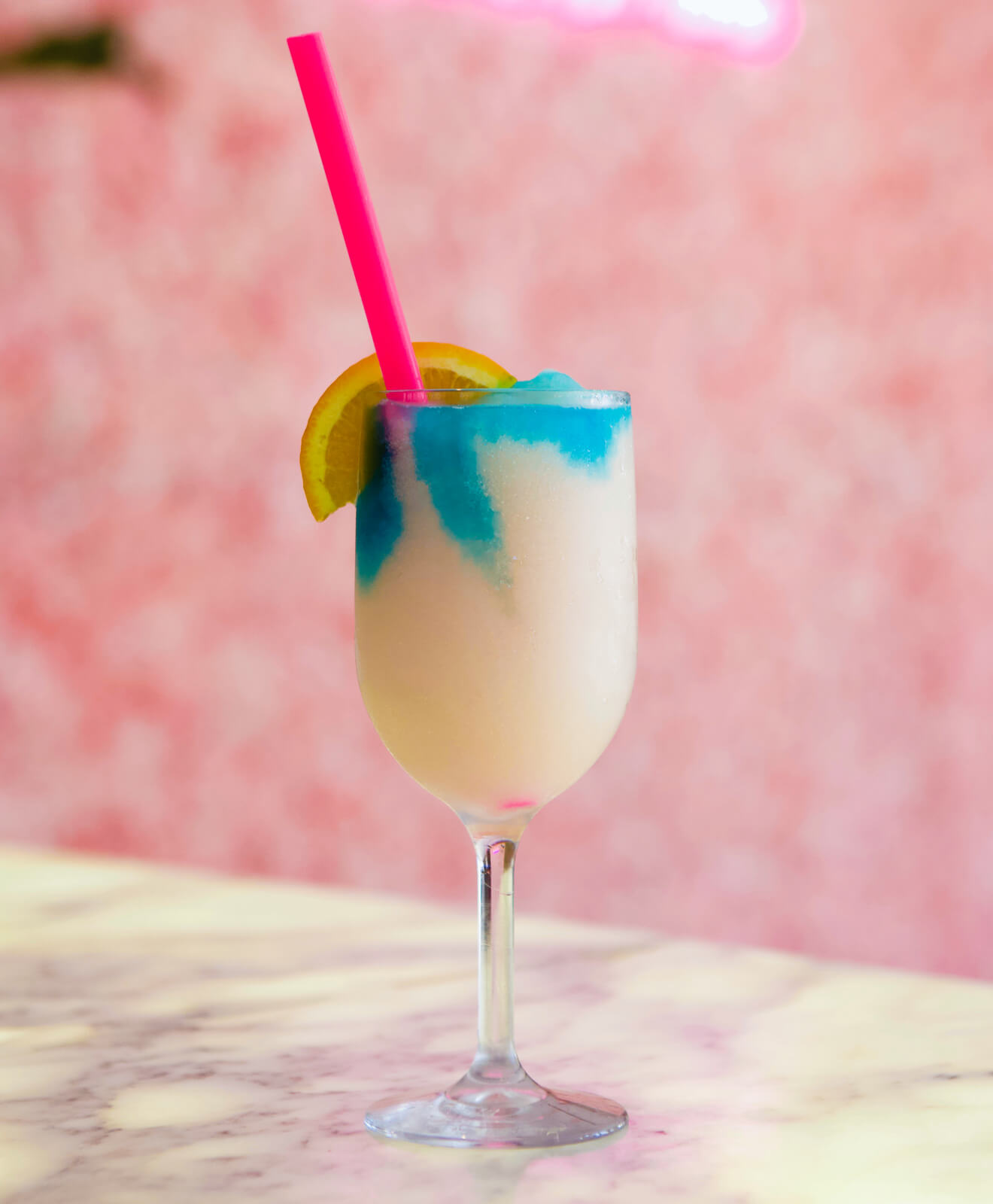 “At Home” Frosé colorful cocktail on pink background