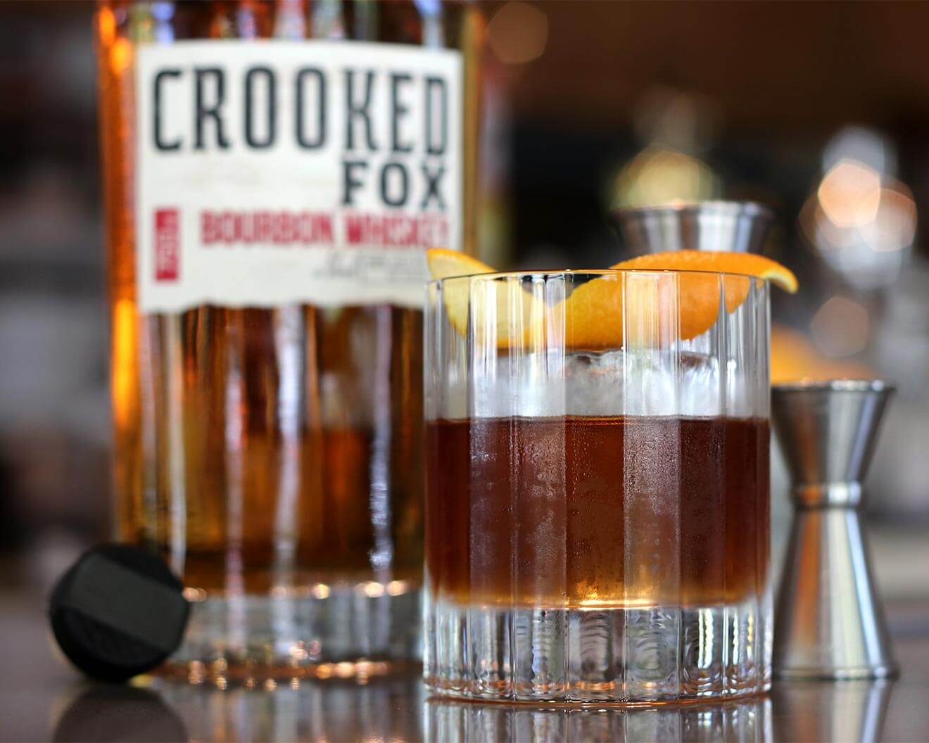 Autumn Leaves cocktail and bottle on bar