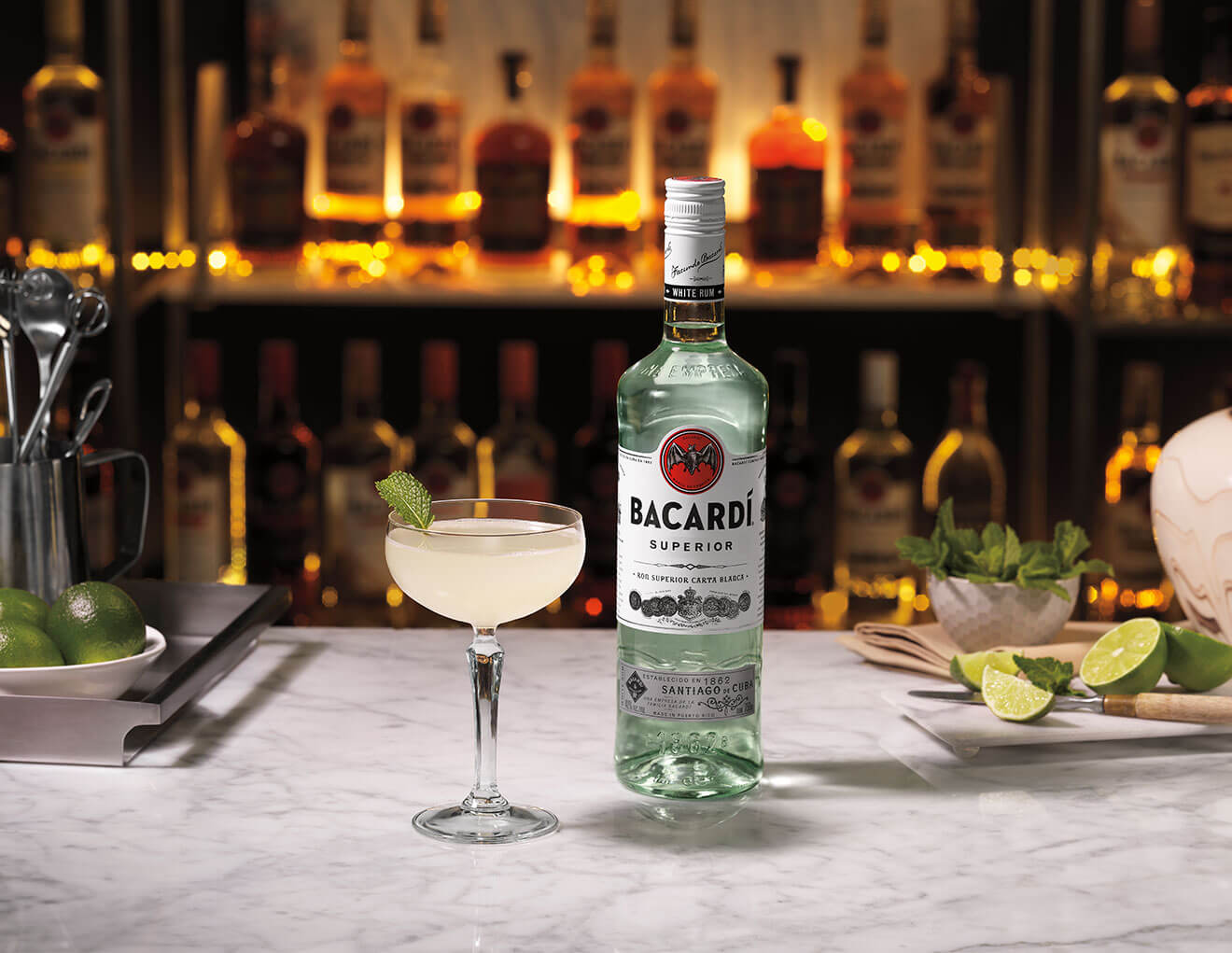 Hand-Shaken Daiquiri, cocktail and bottle with backlit bar