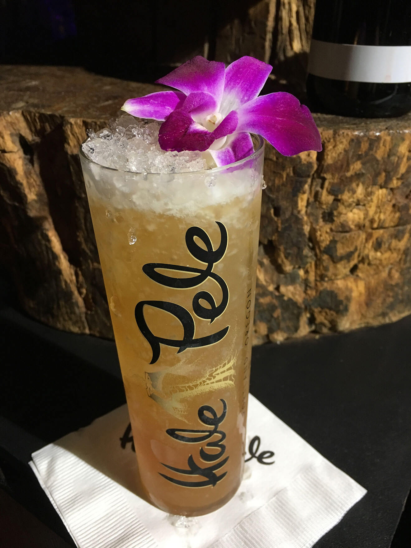 Ooh Barracuda cocktail with flower garnish