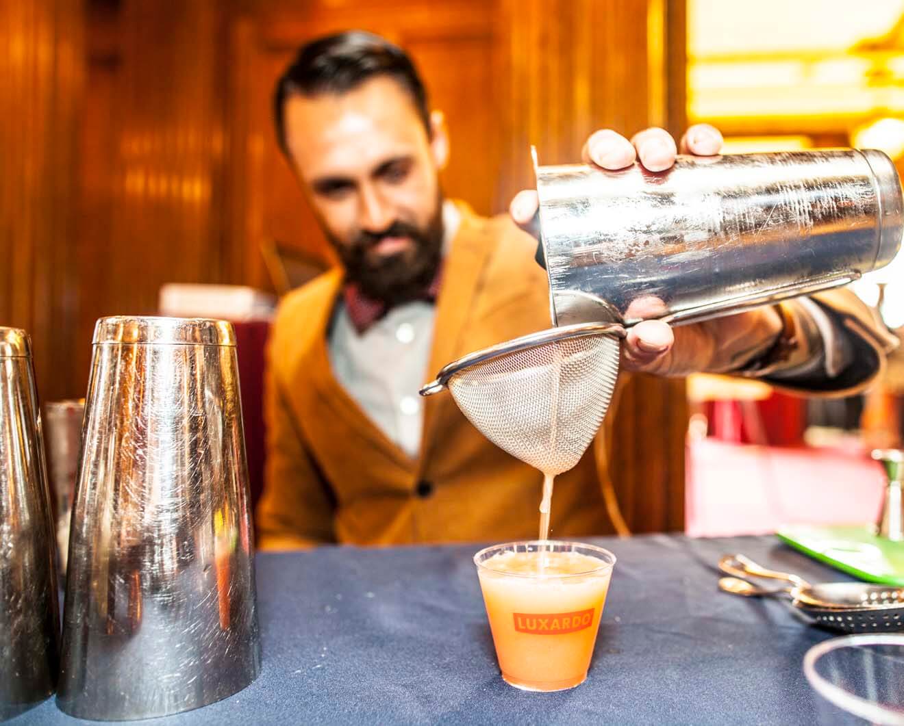 Bartender Competitor Pouring a Cocktail