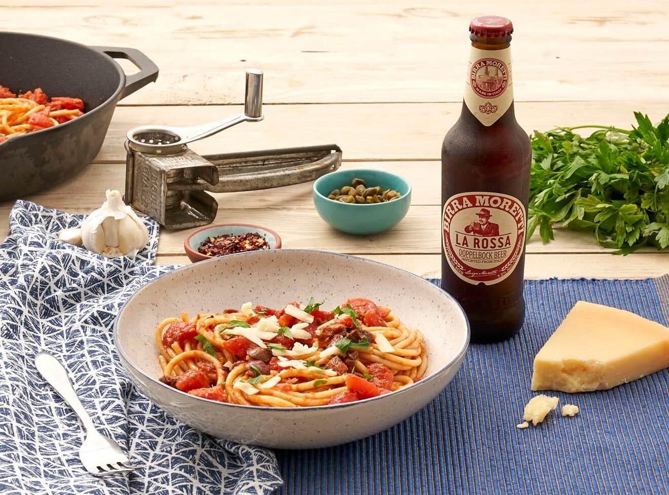 Birra Moretti 'What's More Italian' Summer Program, bottle and dishes display on dining table, garnishes