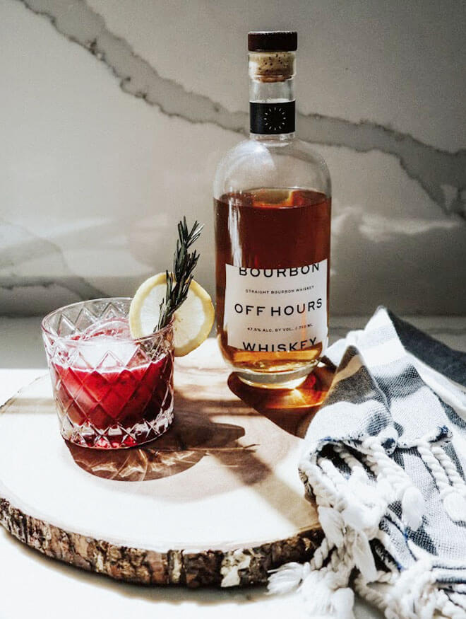 Blackberry Whiskey Sour, cocktail and bottle, log slice