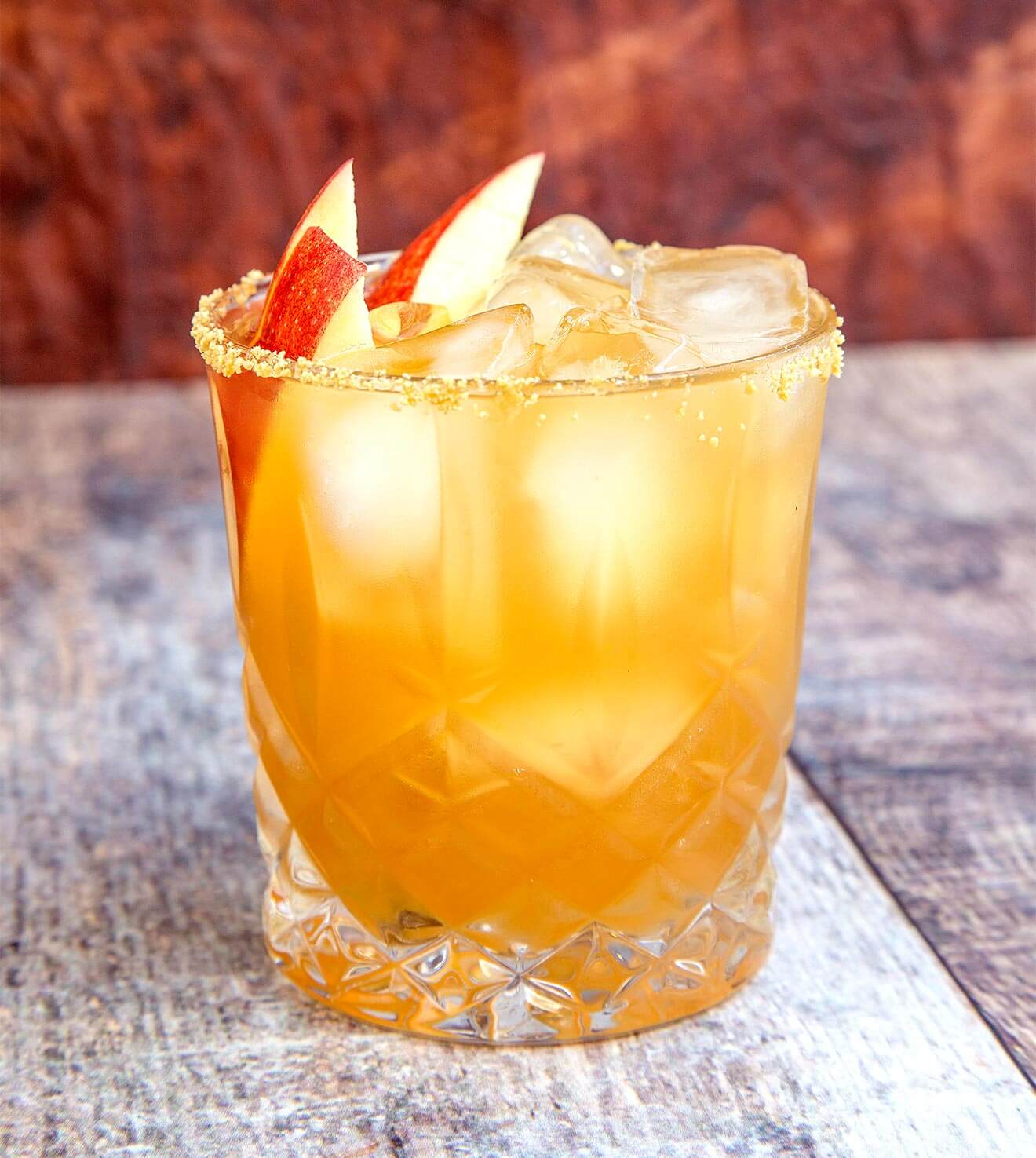 Boulard Apple Fashioned, cocktail and apple garnish, wooden table