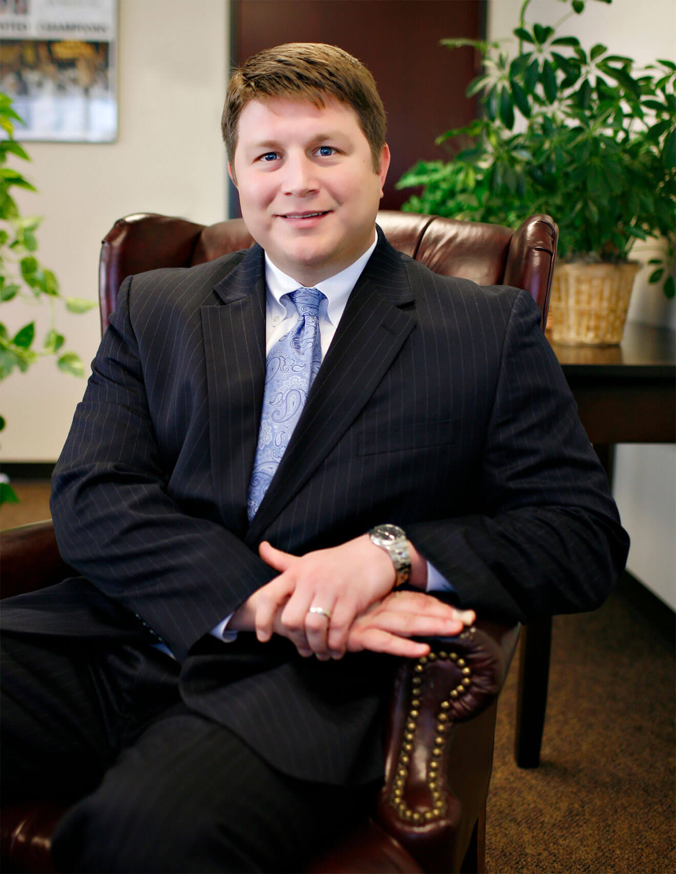Brandon Evans - CEO of Bedlam Vodka, suit in chair pose