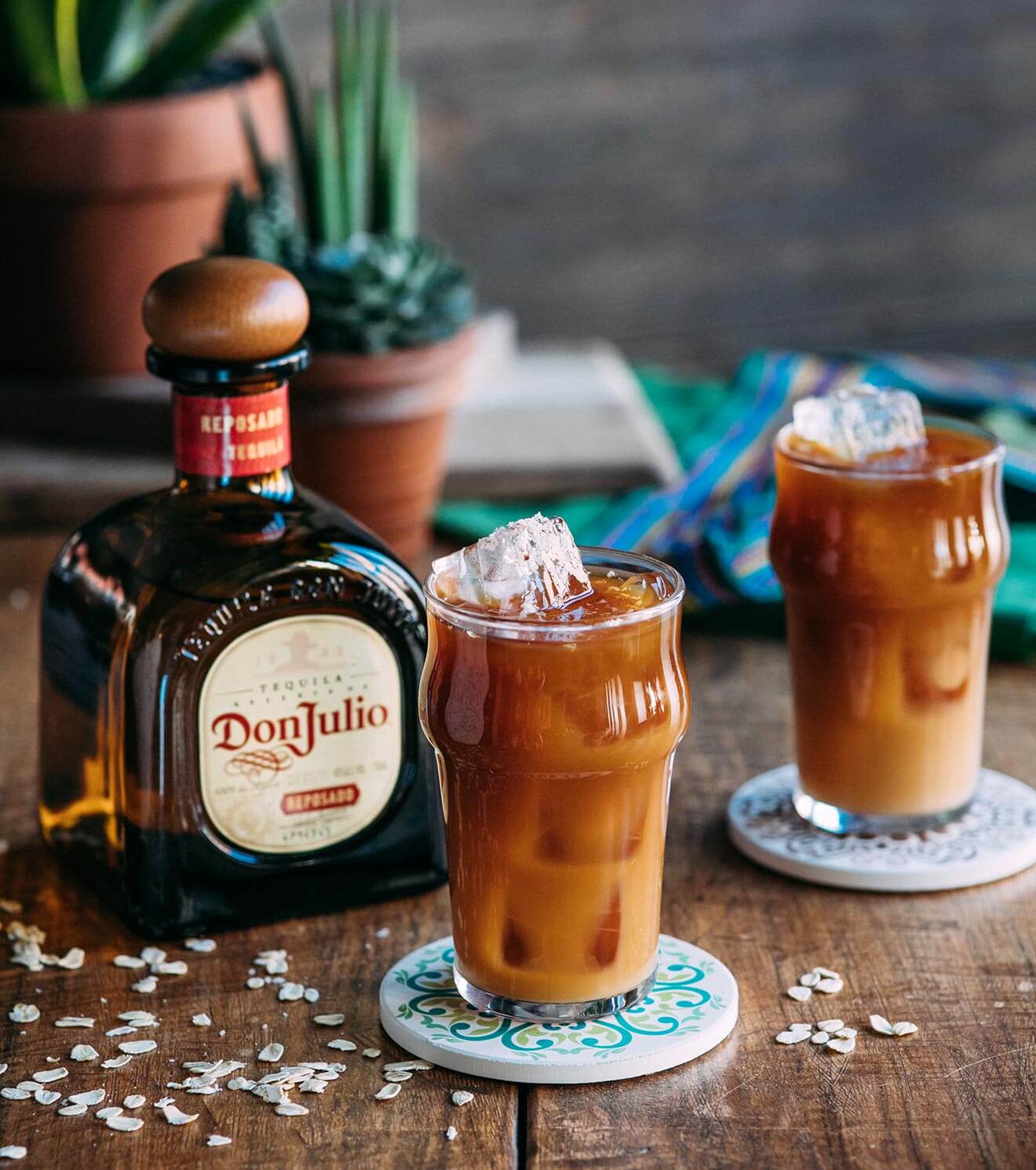 Café Olé, bottle and cocktails with garnish, wooden table