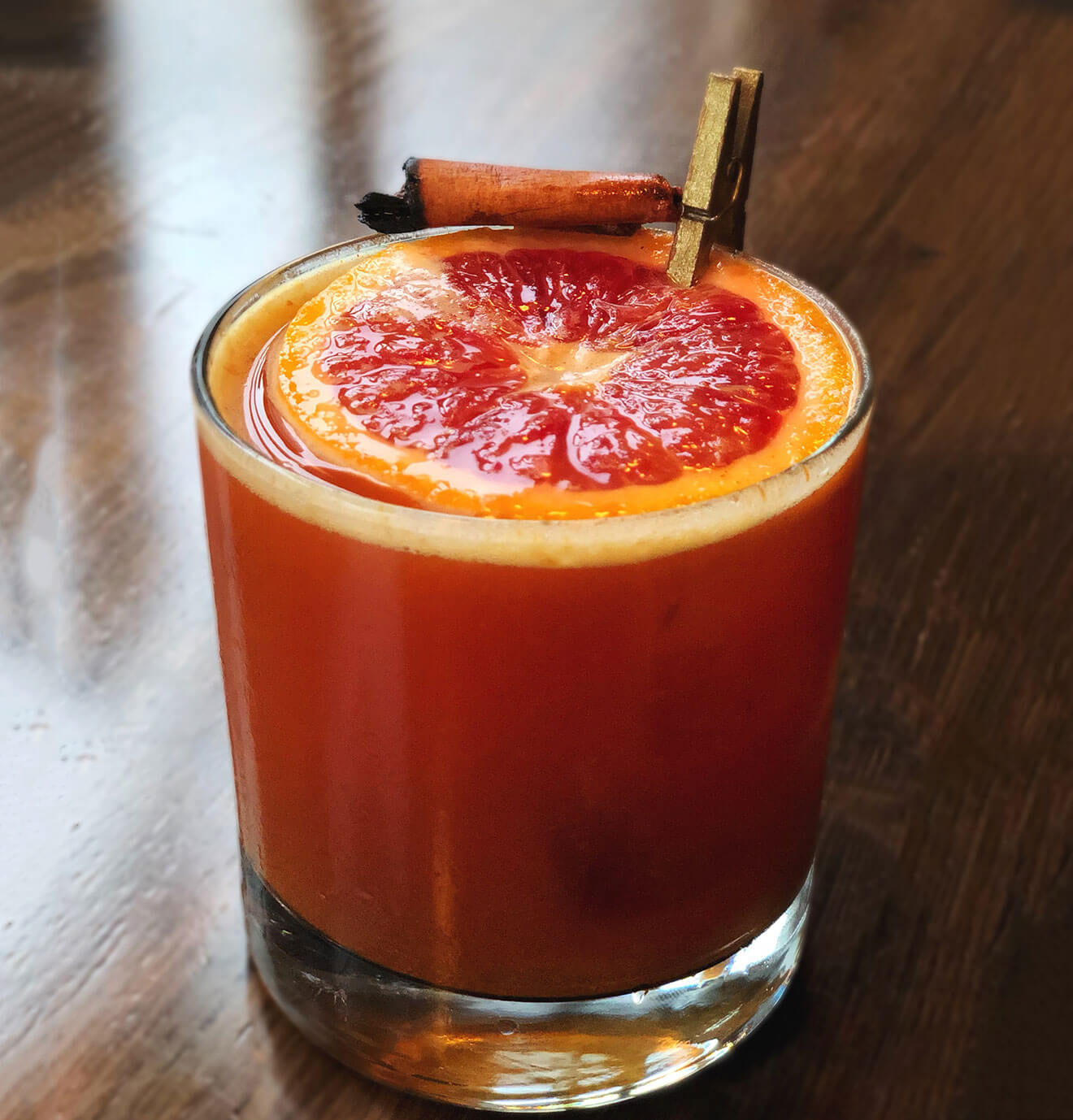 Chakra Opener cocktail with orange garnish