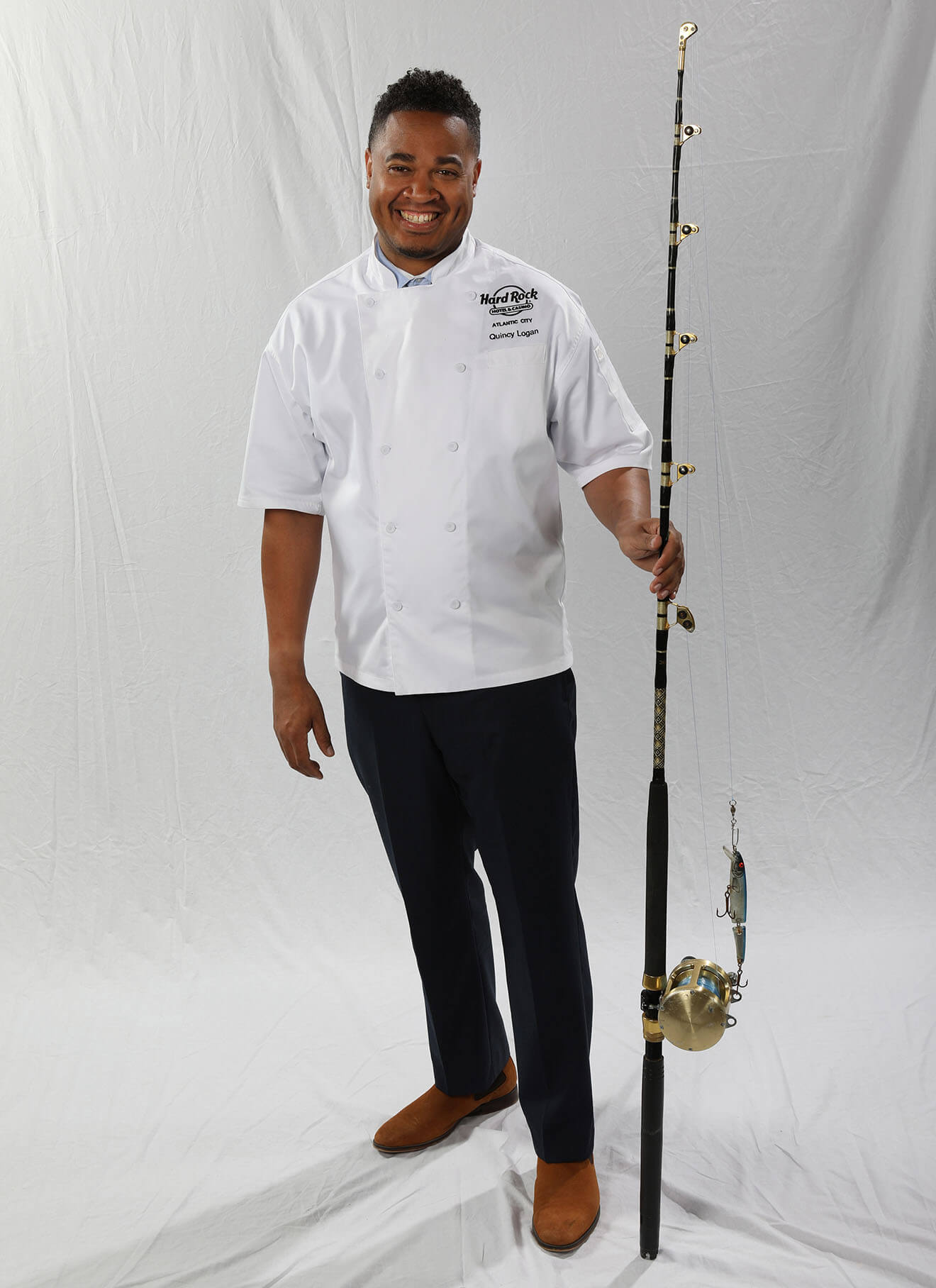 Chef Quincy Logan, fishing pole, light background