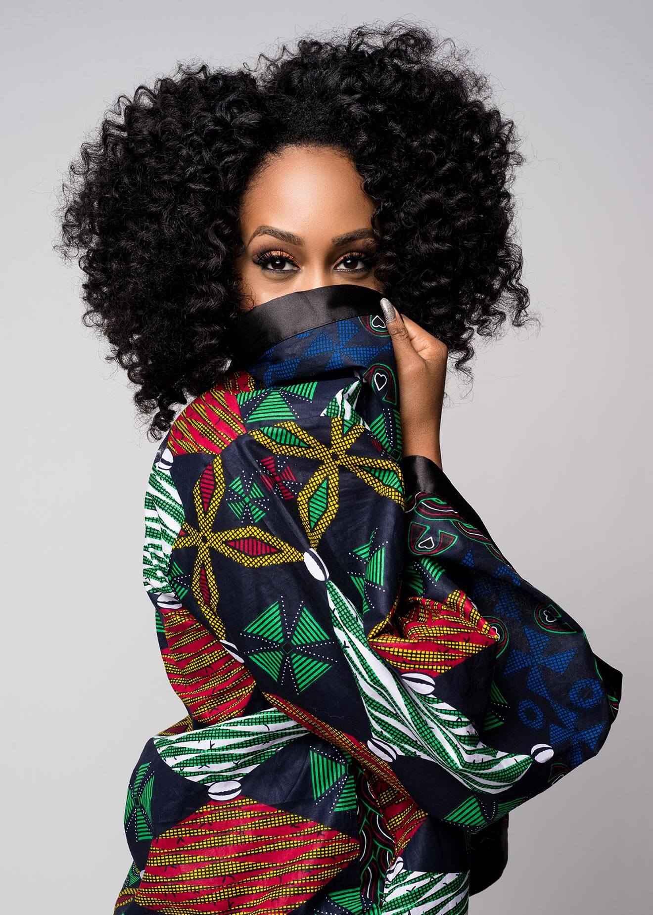 Chillin' with Simone Missick, colorful blouse, covering bottom of face