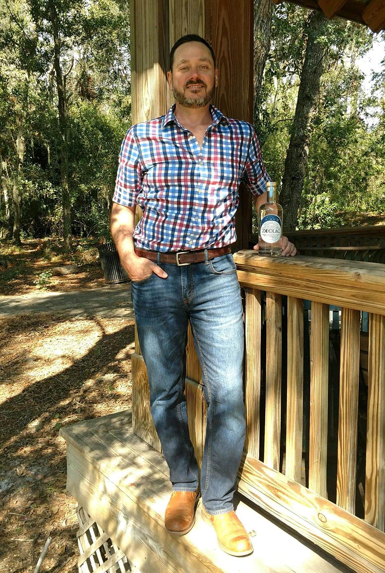 Donovan Graves - VP of Sales for Zodiac Spirits, on porch with bottle