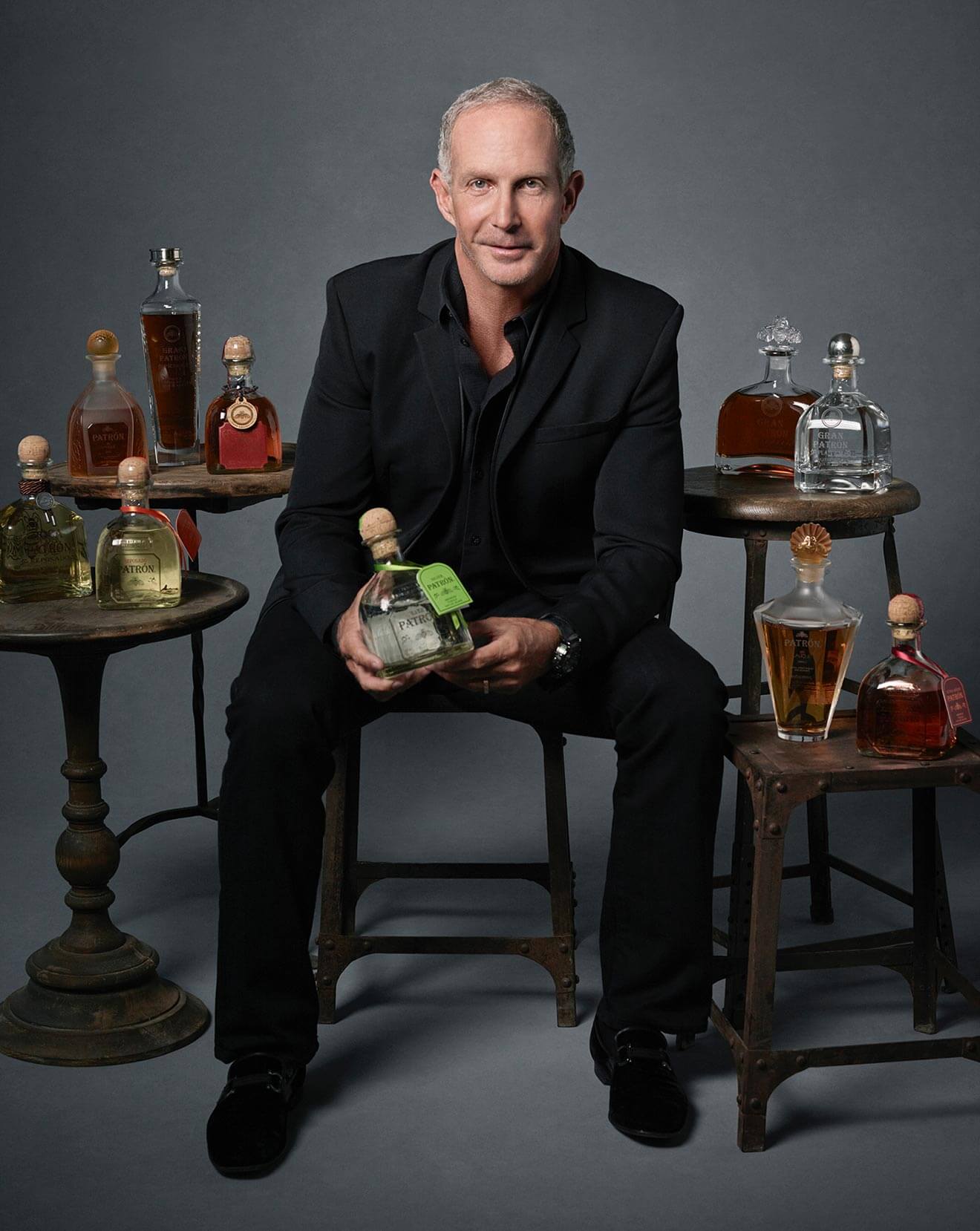 Edward Brown, in chair with fleet of bottles