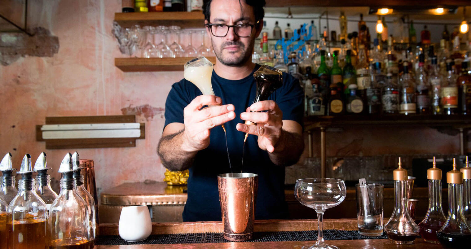 Federico Avila mixing a cocktail behind the bar, featured image