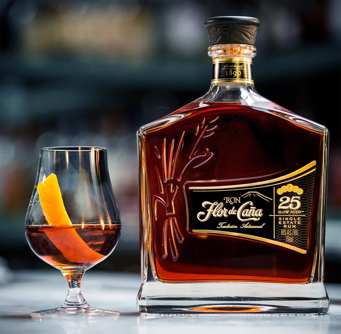Flor de Caña Centenario 25, bottle and glass