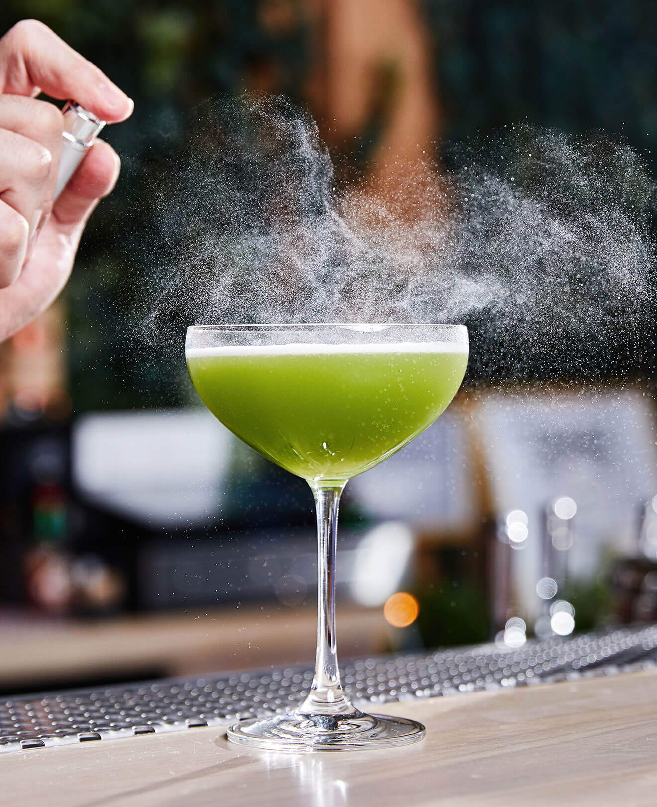 The Gin Game cocktail being garnished by mixologist