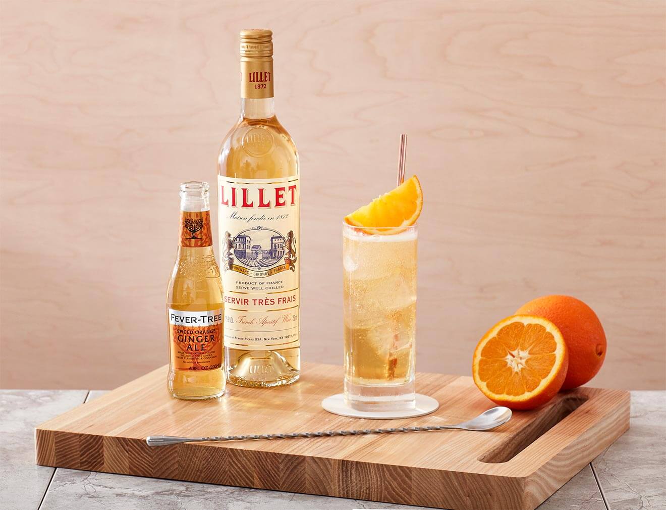 Half Moon Bay cocktail, bottles and garnish on cutting board