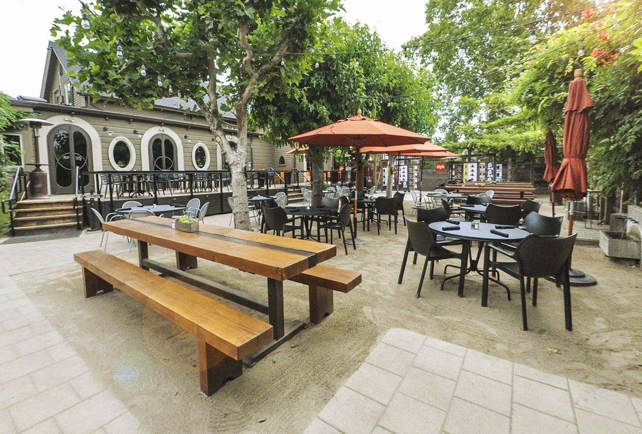 HopMonk Tavern outdoor seating, sand and umbrellas