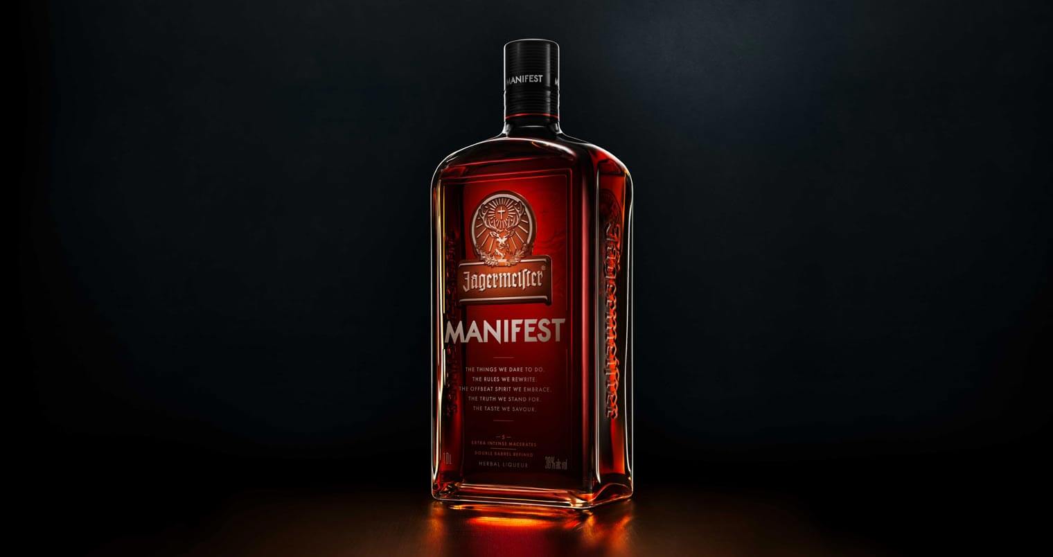 Jägermeister Manifest, dark background, bottle with reflection