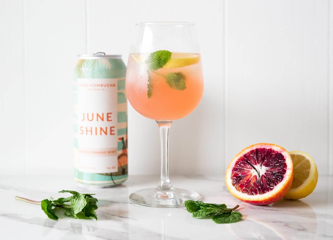 JuneShine Spritz, bottle, cocktail and fruit garnish