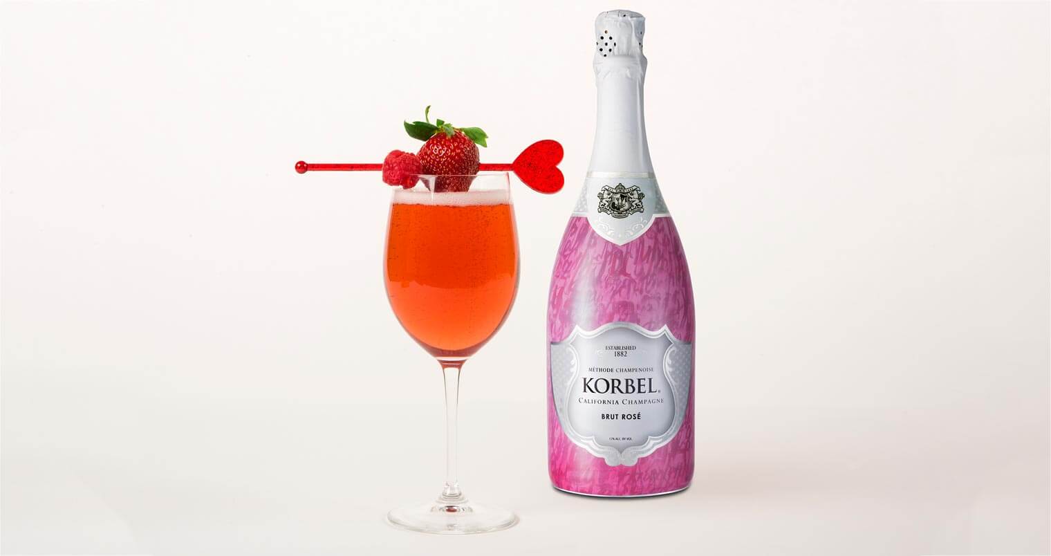 Korbel Ruby Rose, cocktail and bottle on light background, featured image