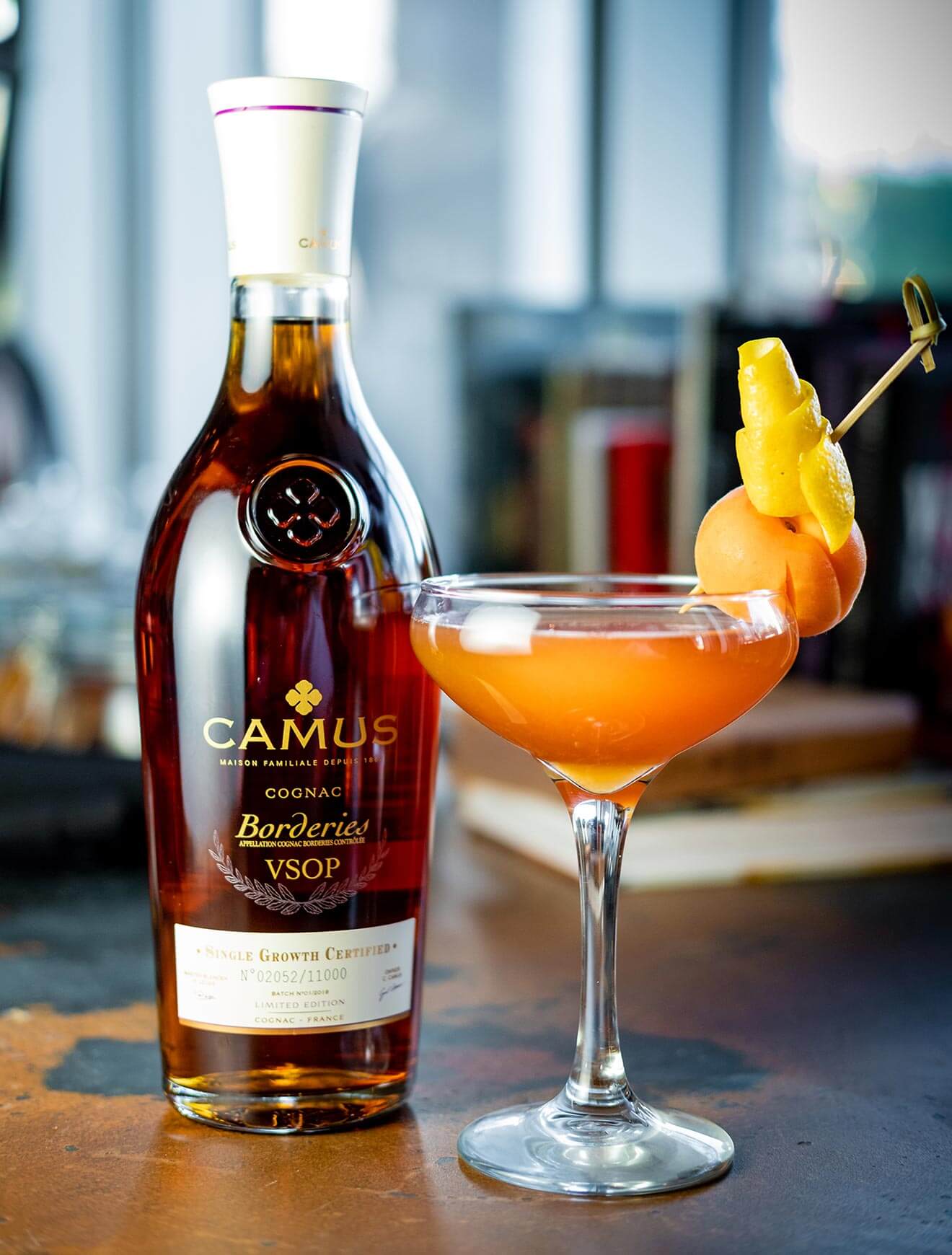 L'abricot Voyageur <em>(The Traveling Apricot)</em>, bottle and cocktail with garnish