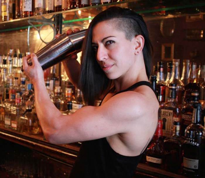 Lana Gailani, Mixologist for the Chilled 100 and other prestigous bars shaking up a cocktail behind the bar