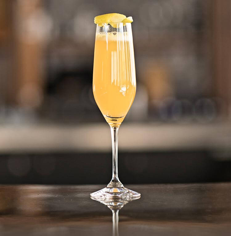 Mandarin Mimosa, cocktail on bar table
