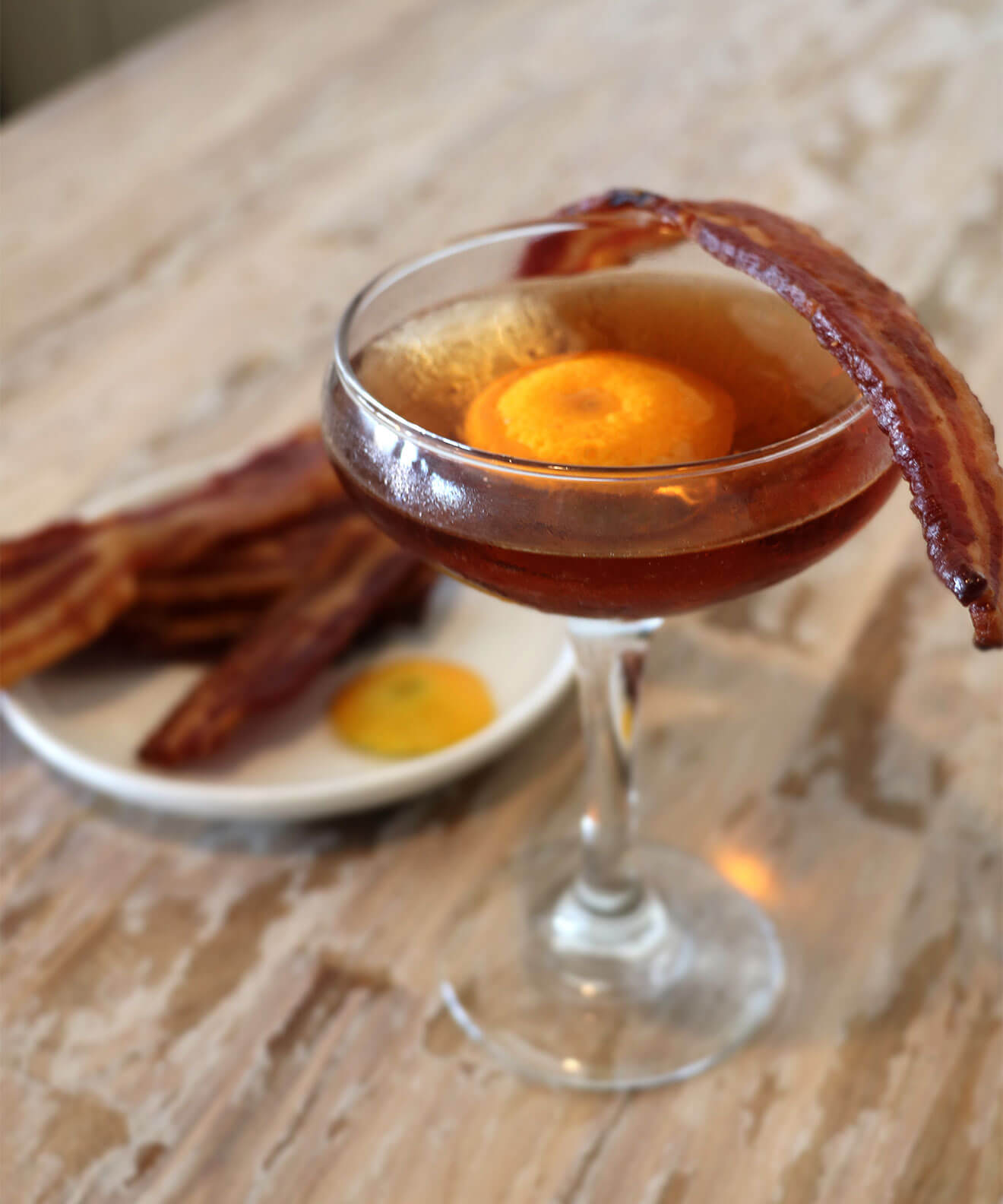 Maple Bacon Old Fashioned, cocktail with bacon garnish, breakfast on table