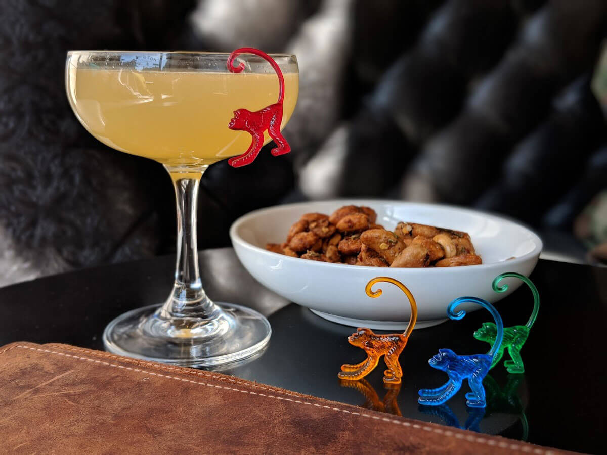 Melon See, Melon Dew cocktail with garnish, hanging monkeys