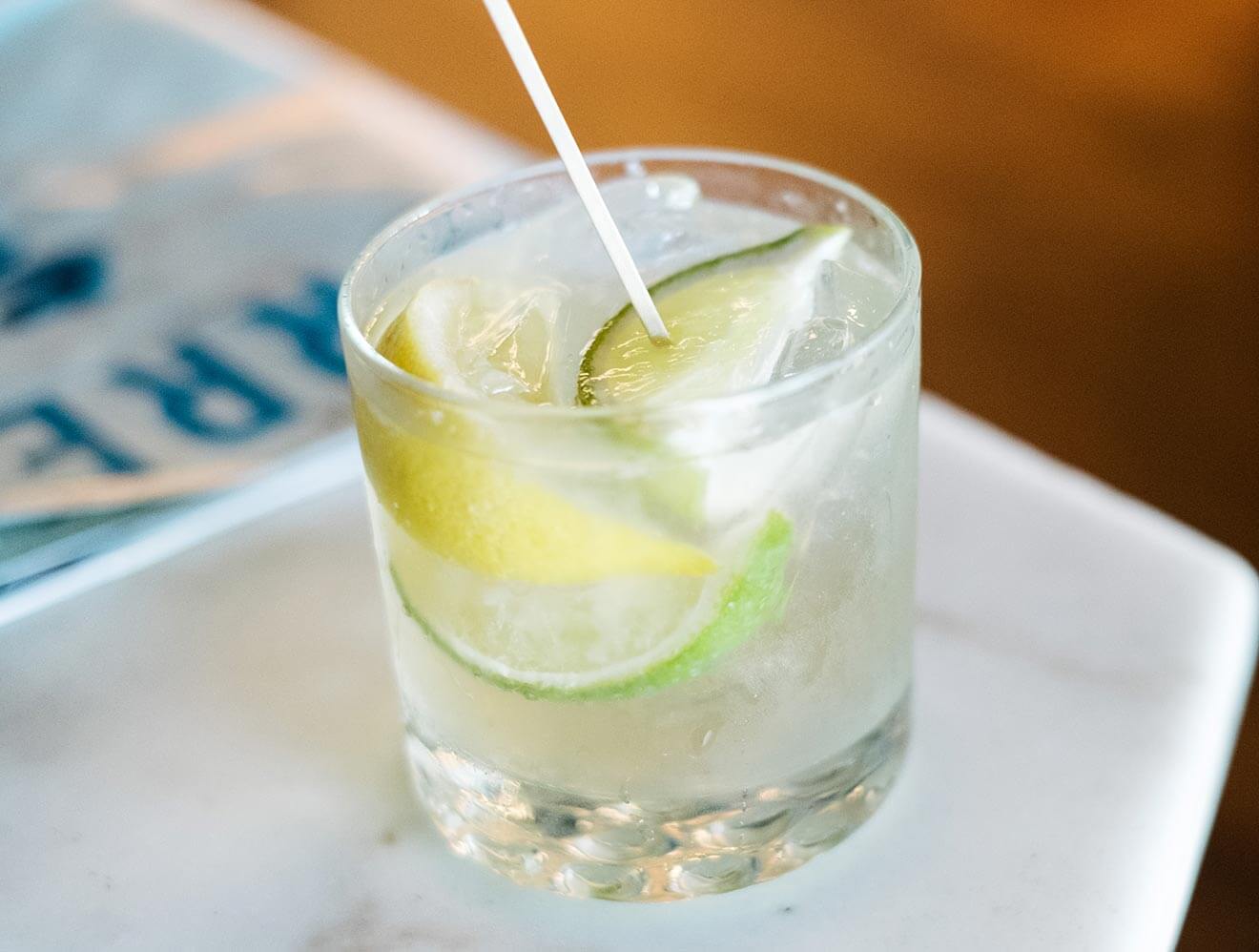 Mexican Bucha cocktail with lime wedges