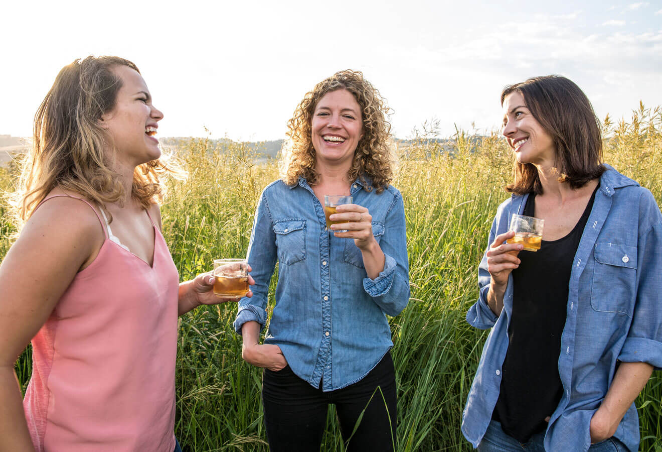 Molly Troupe, Jill Kuehler & Cory Carman, laughing and enjoying a bevarage