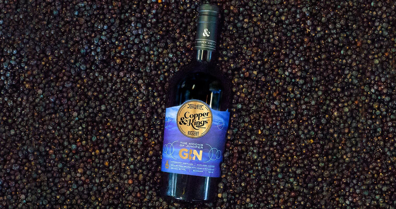 Moons of Juniper Gin, bottle on berries, featured image