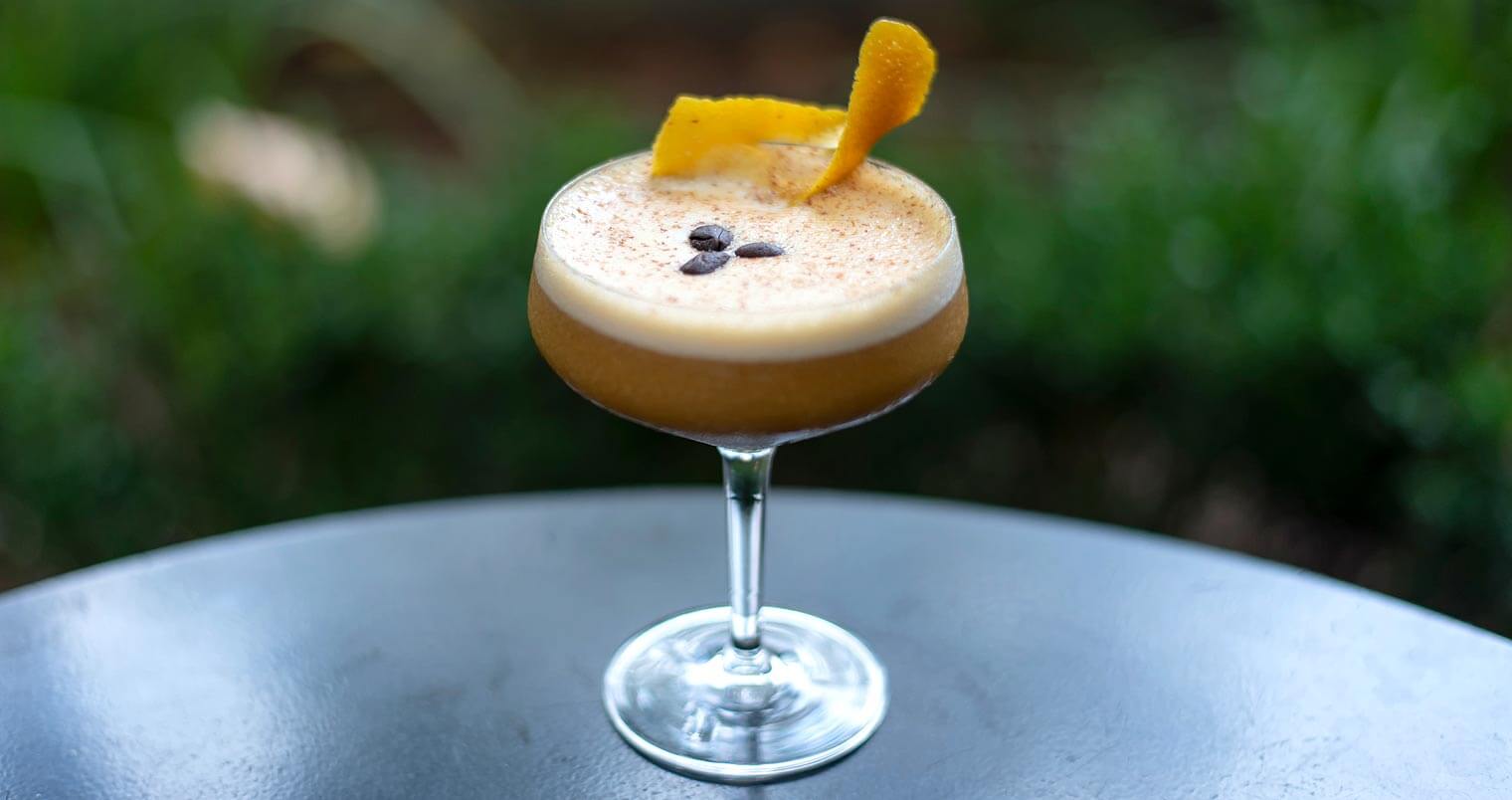 Pumpkin Spiced Latte, cocktail with garnish on table, featured image