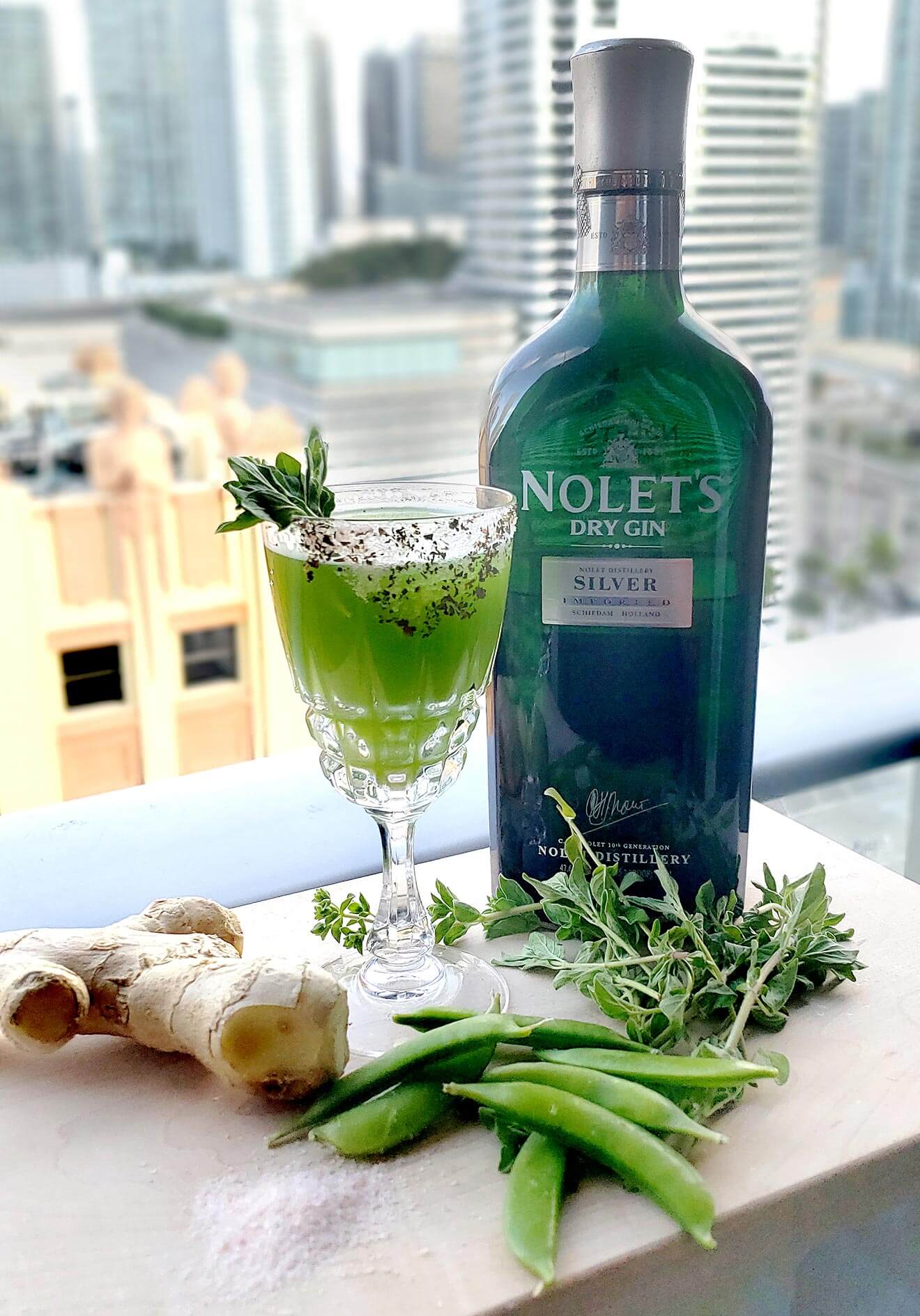 My Herbal Garden, cocktail, bottle and garnish, city scape backdrop