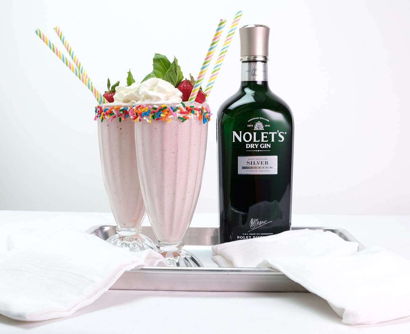 NOLET’S Spiked Strawberry Milkshake, cocktails and bottle on silver tray