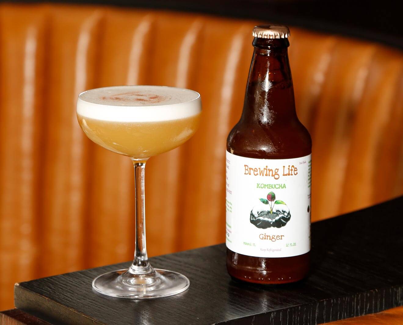 Nauti Pleasure, cocktail and bottle on table top