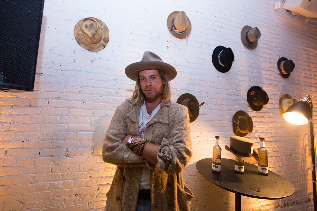 Fashion Hat Designer Nick Fouquet with a collection of hats on display, featured brands