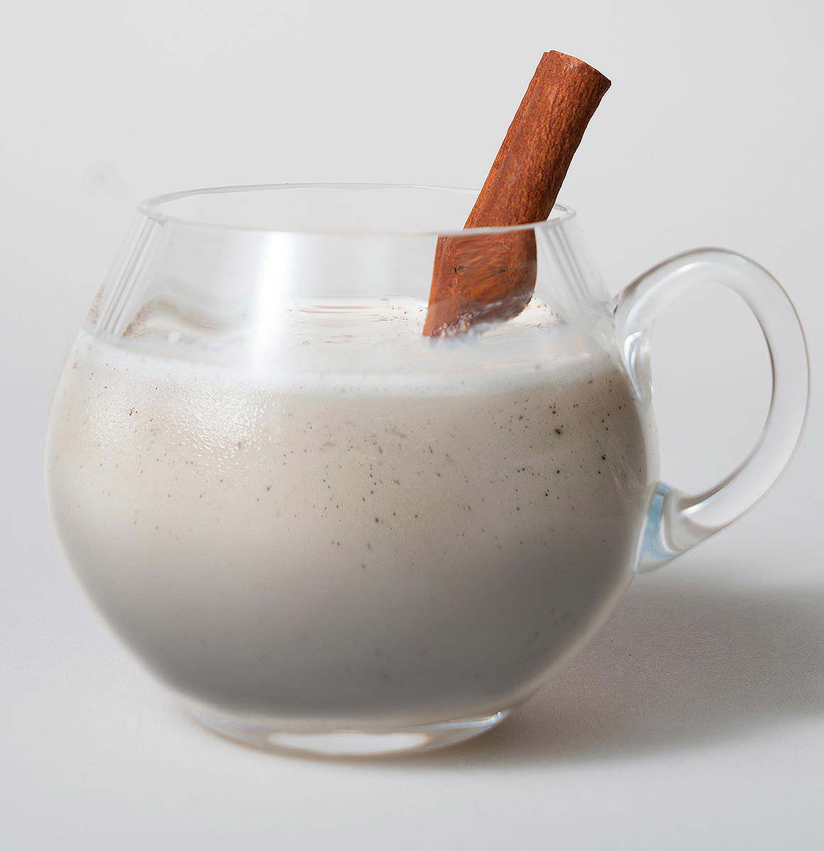 Noggy Root, cocktail with cinnamon garnish on white