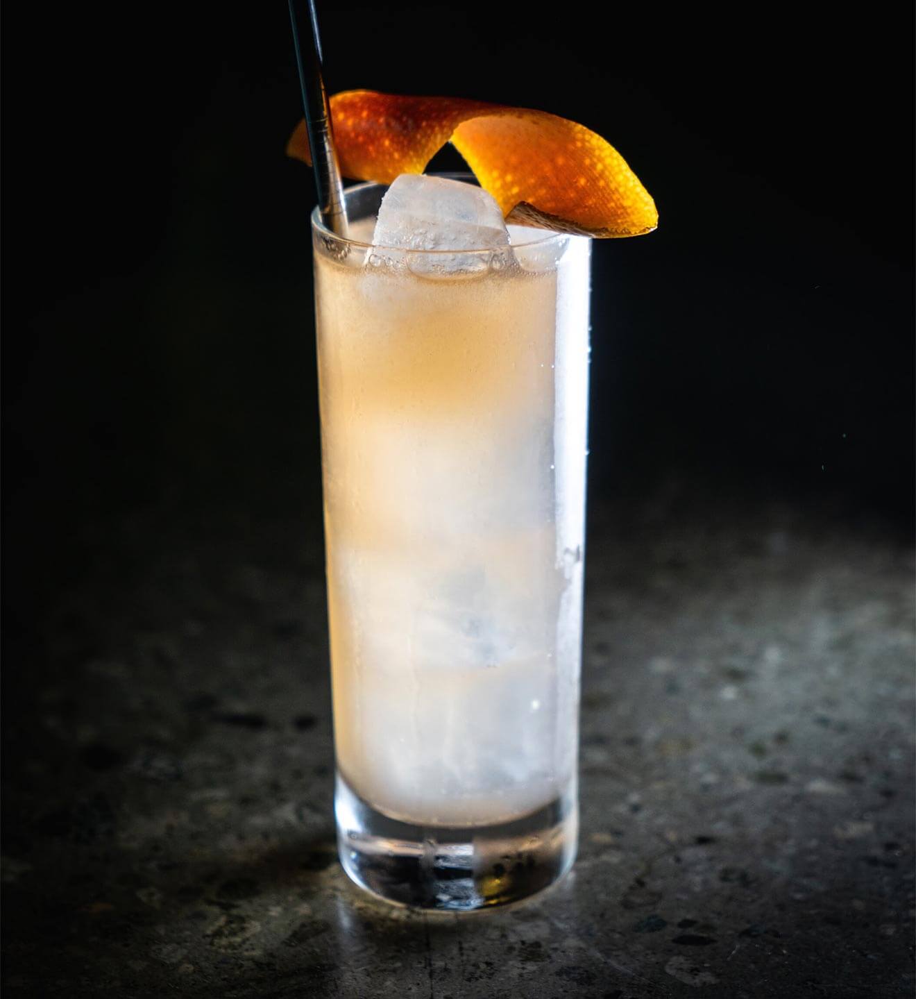 Oaxacan Spritz, cocktail with garnish on dark background