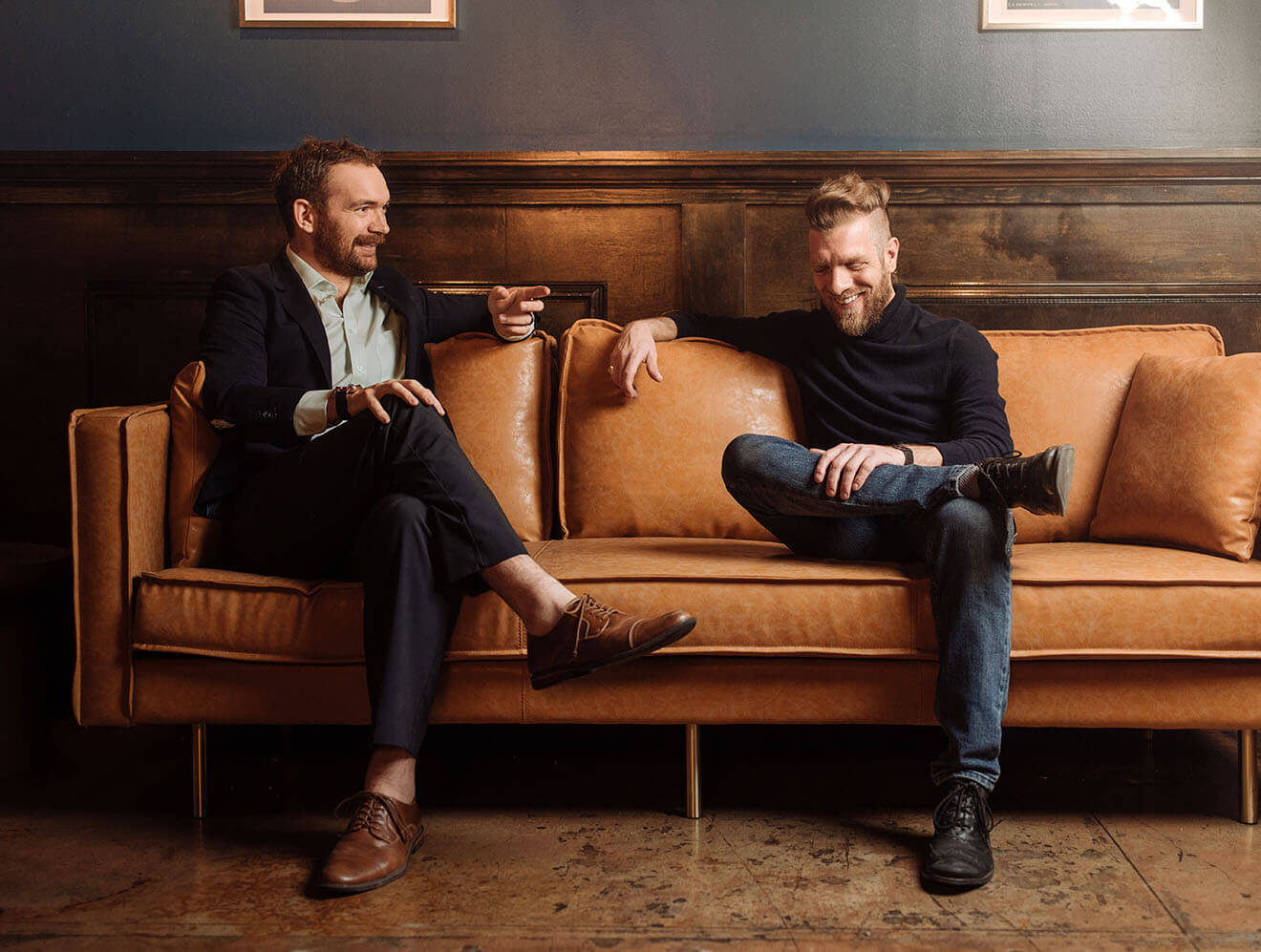 Owners Lucas Bradbury and Benjamin Krick, sitting on couch in conversation