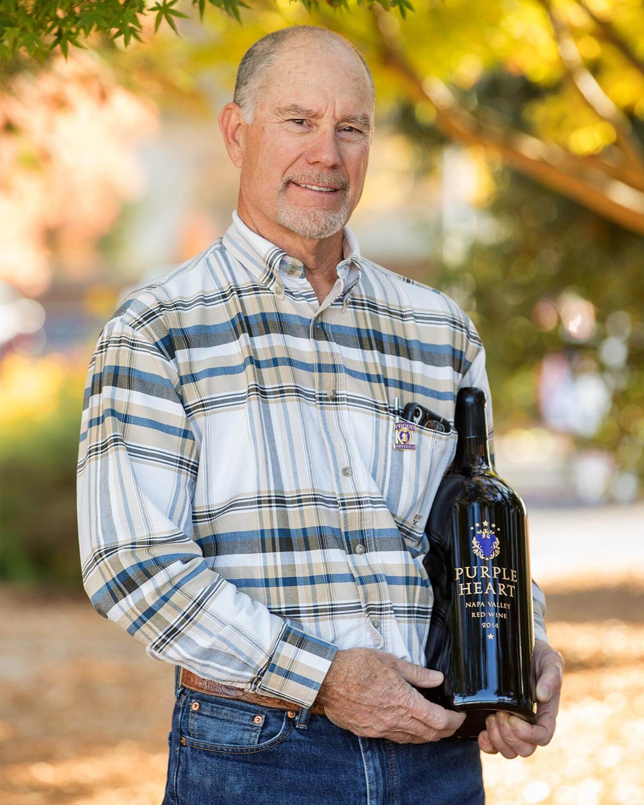 John Moynier in Vineyard with Bottle