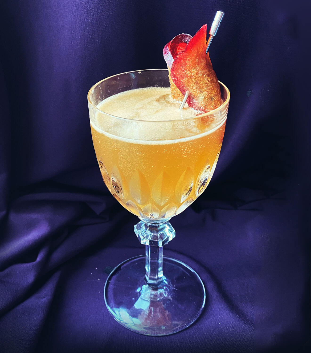Plum’s the Word, cocktail with garnish, blue velvet back