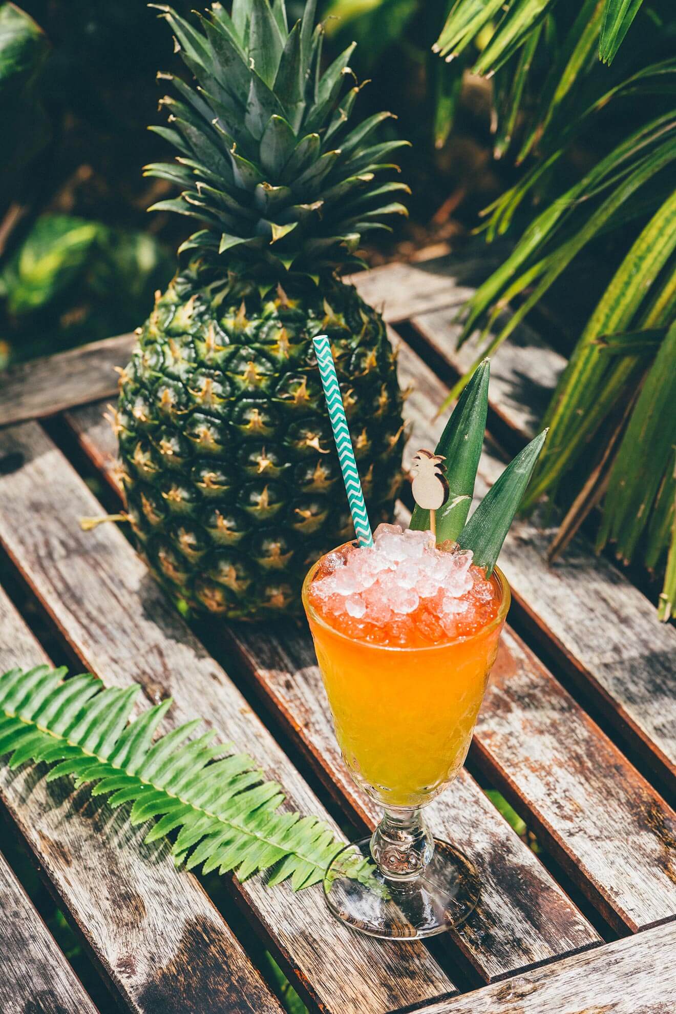 Last Concho cocktail with pineapple, outdoor shot on wood deck