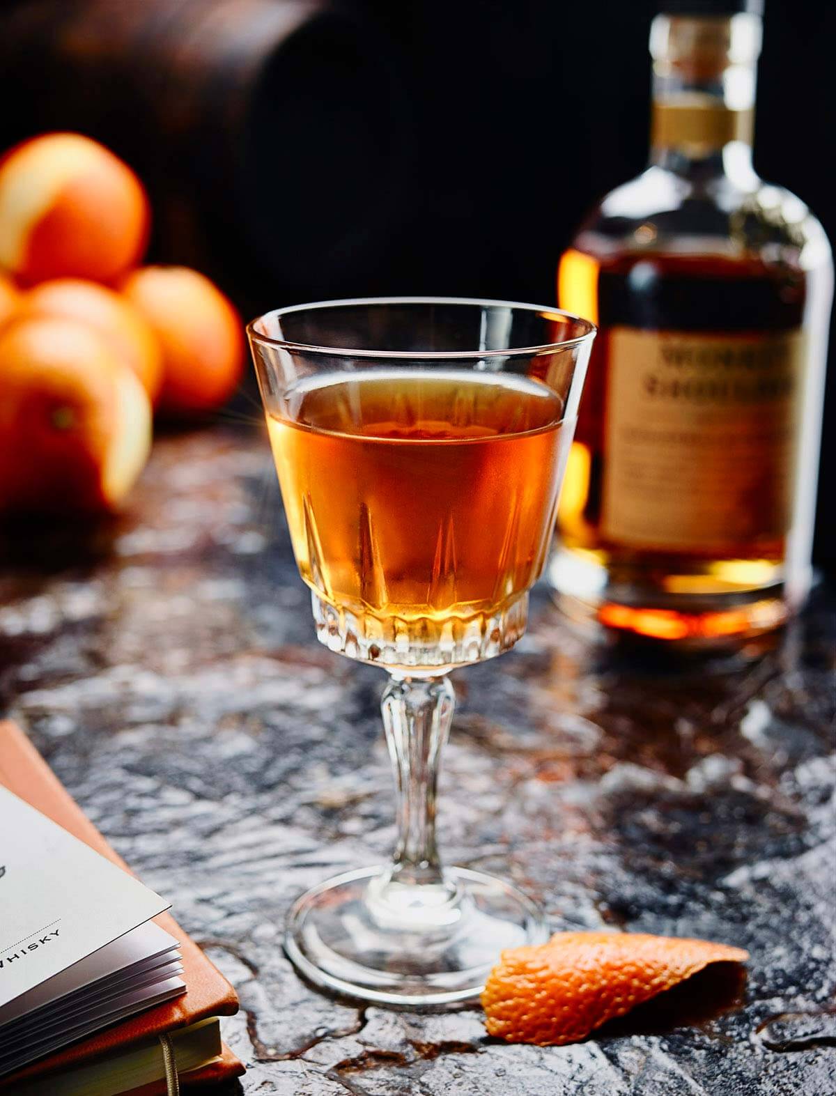 Royal Cosmographer, cocktail and bottles on dark background