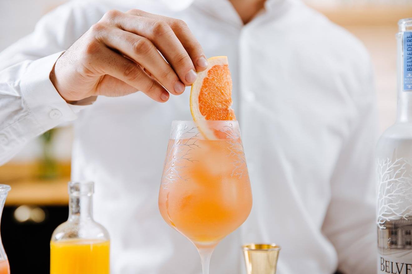 Belvedere Rubin Cocktail, kitchen display with bottle, garnishes and cocktail
