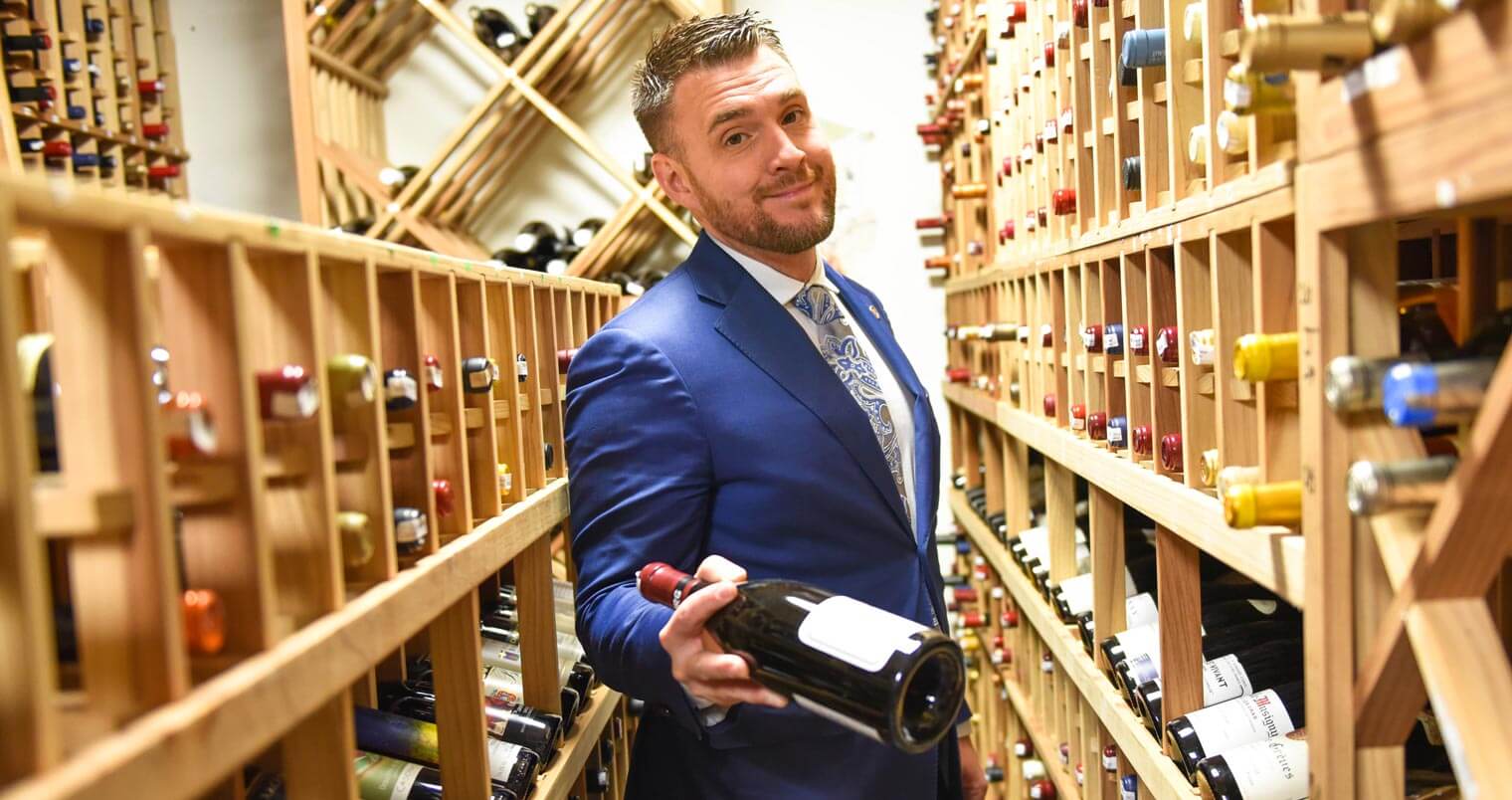 Ryan Baldwin Presenting a Bottle, wine storage room, featured image