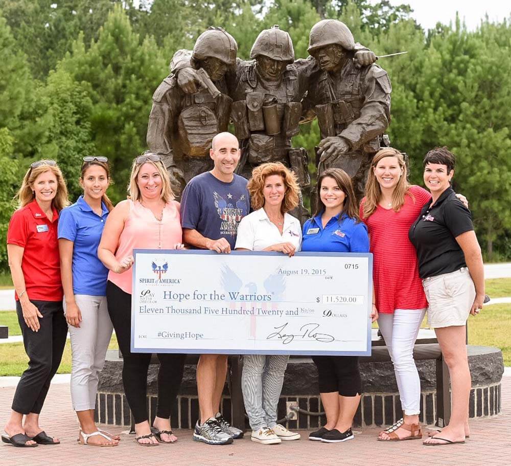 Founder of Spirit of America® Handcrafted Bourbon, Lenny Roberts (center) presents check to Hope for Warriors®at Marine Corps Base Camp Lejeune in Jacksonville, NC